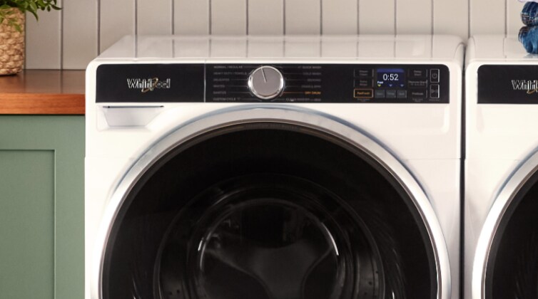 A closeup of a Whirlpool® washer in a laundry room