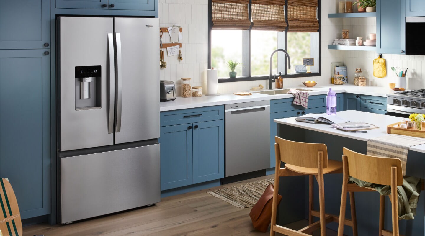 Stainless steel Whirlpool® French door refrigerator in blue cabinetry