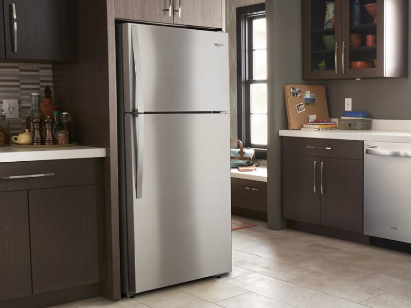 Stainless steel Whirlpool® Top-Freezer Refrigerator in brown cabinetry Stainless steel Whirlpool® Top-Freezer Refrigerator in brown cabinetry