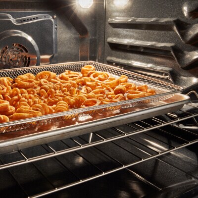 Curly fries inside an oven