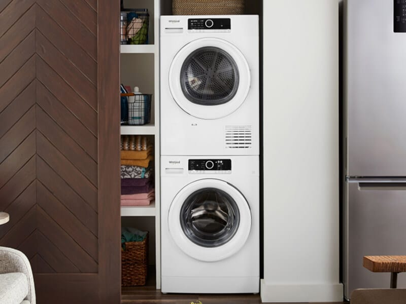 Compact laundry tower behind a sliding closet door