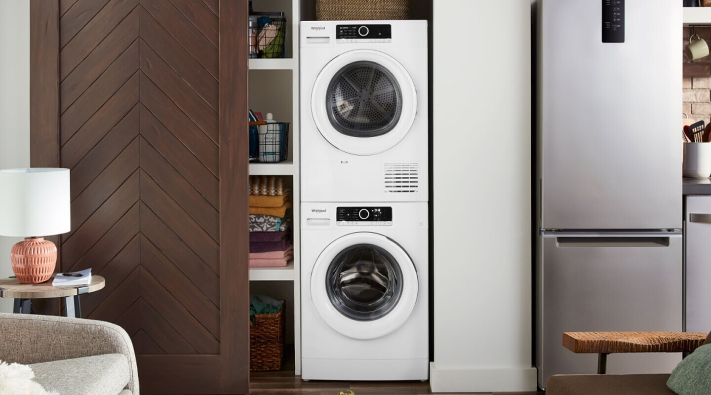 Compact laundry tower behind a sliding closet door