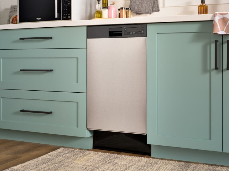 An 18" Whirlpool® Dishwasher in mint green cabinetry
