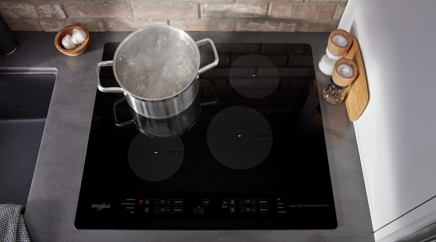 Pot of water boiling on an electric cooktop