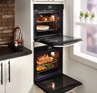  A black double oven set in white cabinetry