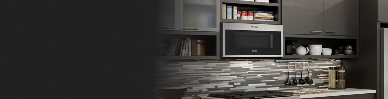 A Whirlpool® microwave installed over a gas range