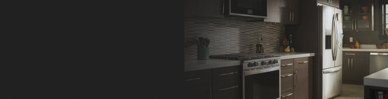 A kitchen with brown cabinets and stainless steel appliances