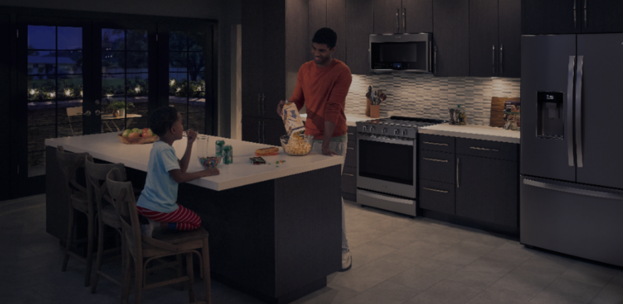Father and daughter in the kitchen.