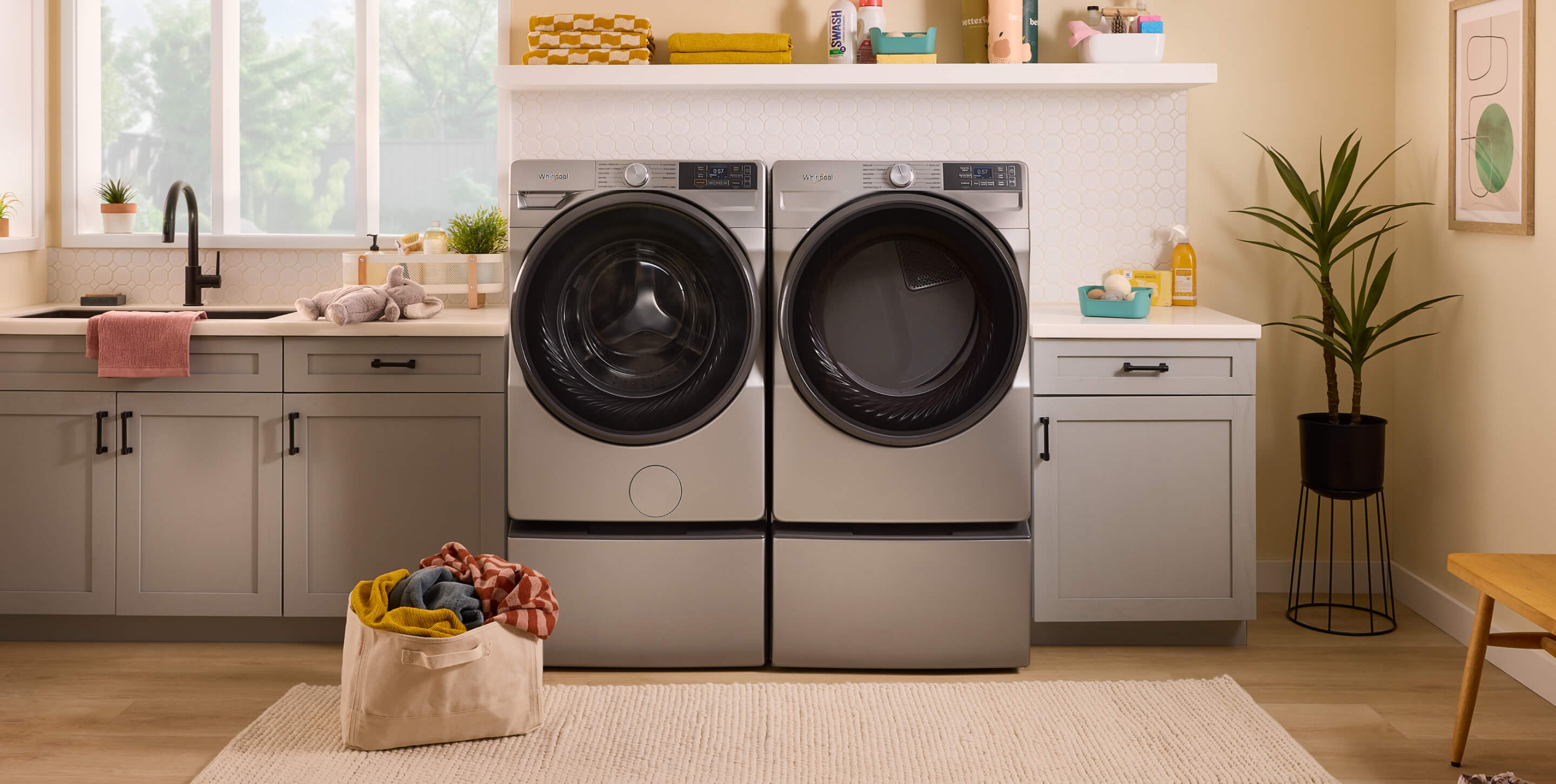 A Whirlpool® Front Load Washer and Dryer Pair in a laundry room.