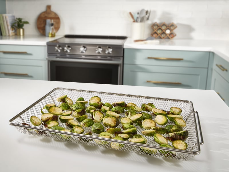 Brussels sprouts in an air fry basket Brussels sprouts in an air fry basket