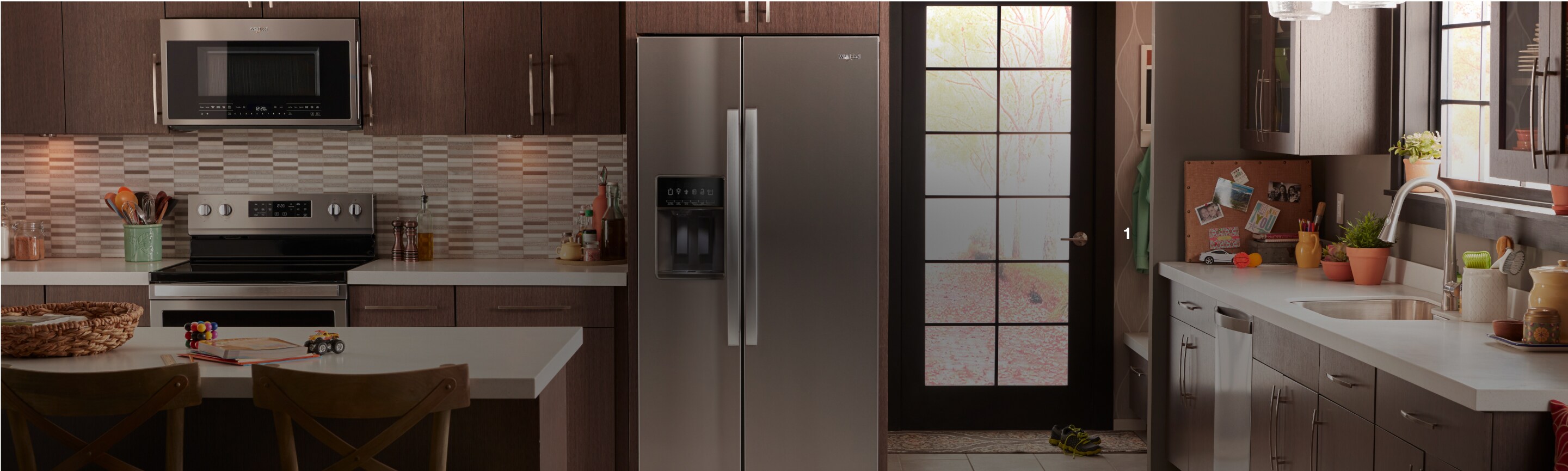 Whirlpool® kitchen suite featuring an electric range and side-by-side refrigerator.