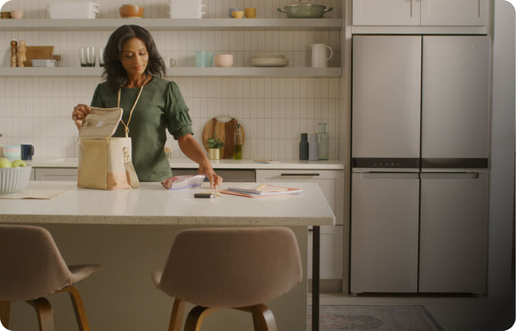 A person loading a lunch bag in a kitchen