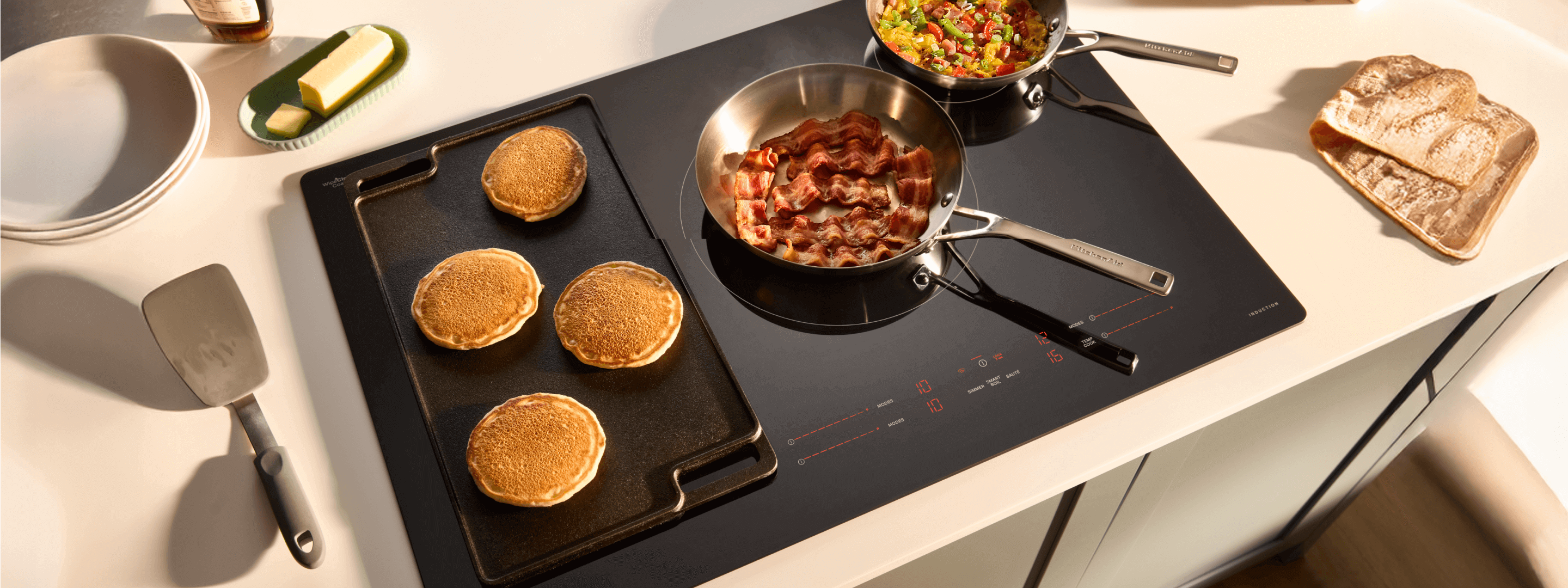 Multiple pans and a griddle on a Whirlpool® Induction Cooktop