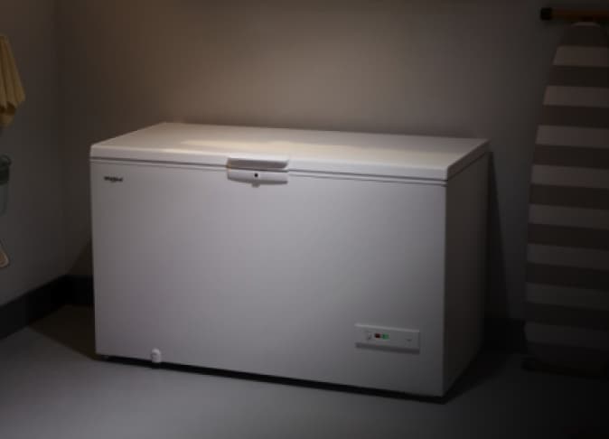 A Whirlpool® Deep Freezer in a garage