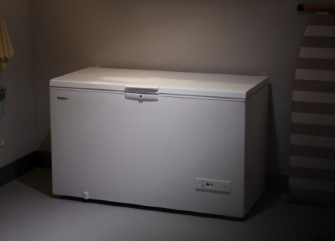 A Whirlpool® Deep Freezer in a garage