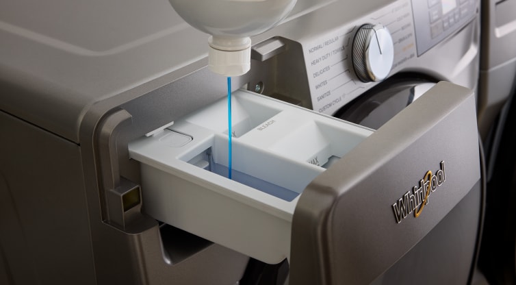 Laundry detergent is poured into a Whirlpool® Washer with a Load & Go™ Dispenser