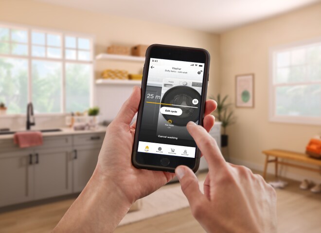 Hand holding a phone and tapping on the Whirlpool® App