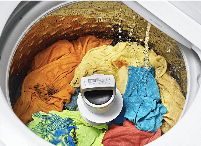 Water filling a washer that's filled with clothes