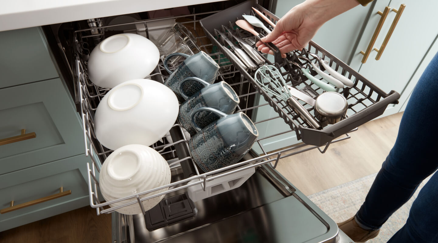 A person loading the third rack of a dishwasher
