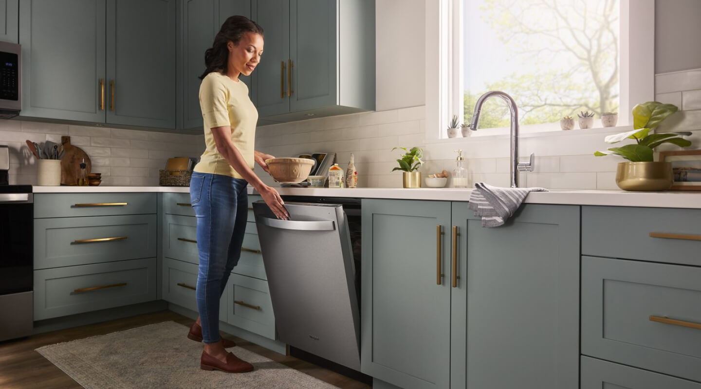 Person closing a dishwasher