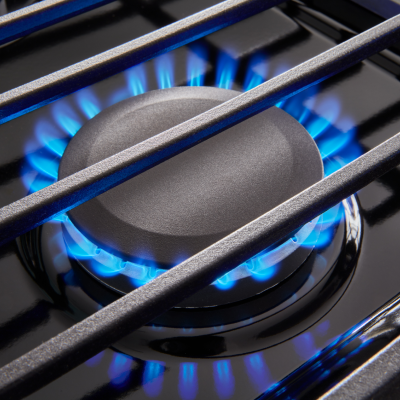 Gas burners ignited with blue flames.
