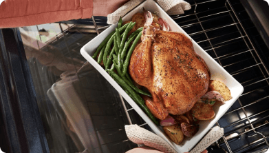 Roasted chicken and asparagus in a pan.