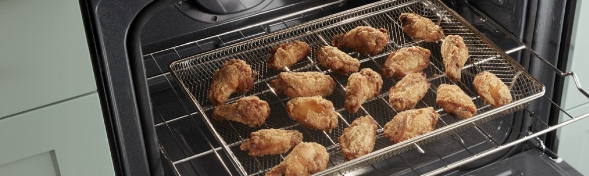 Chicken wings air frying in a Whirlpool® Standard Electric Range
