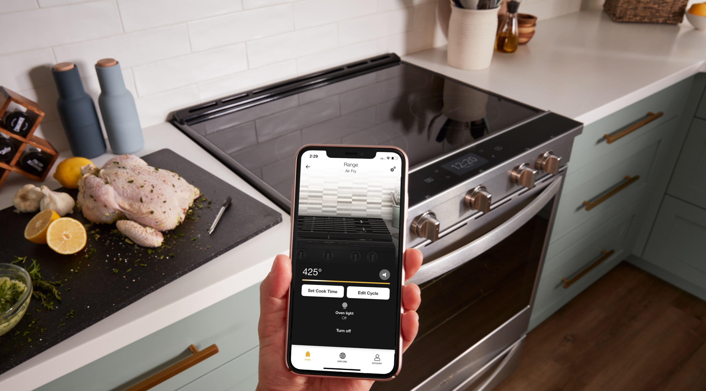 A phone using the Whirlpool® App to control a Whirlpool® Smart Slide-In Range in a kitchen