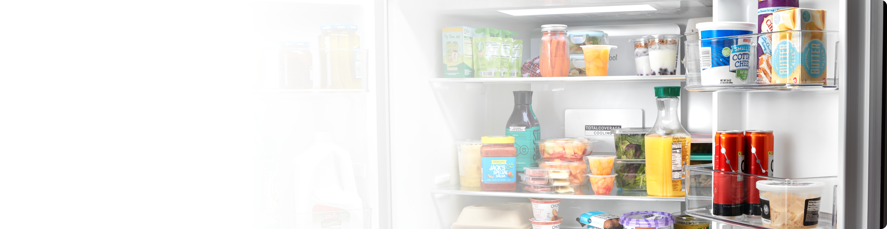 An open Whirlpool® 4 Door Refrigerator in a kitchen