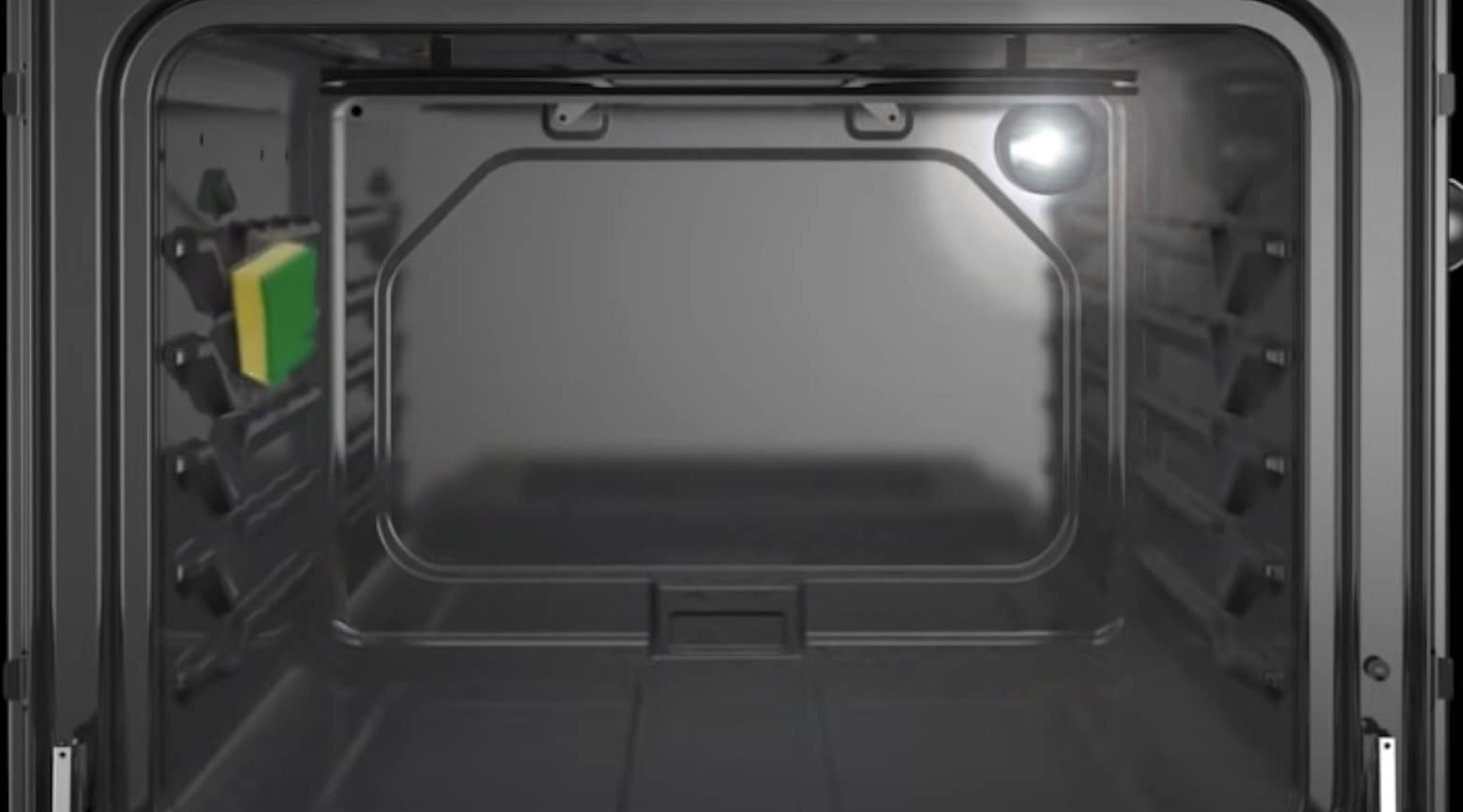 Oven cavity being wiped with a sponge