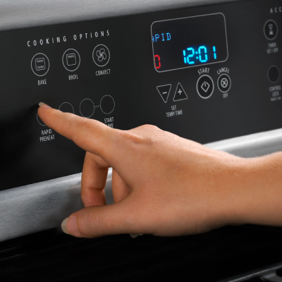 Person selecting the rapid preheat option on oven