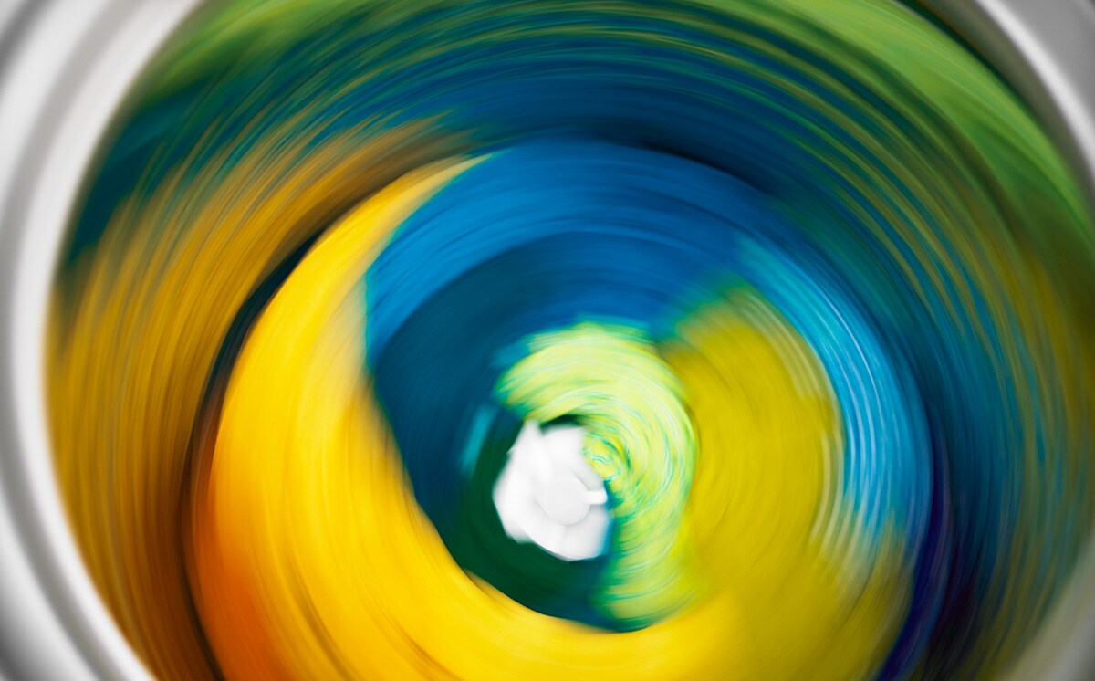  A load of colorful clothing going through a spin cycle.
