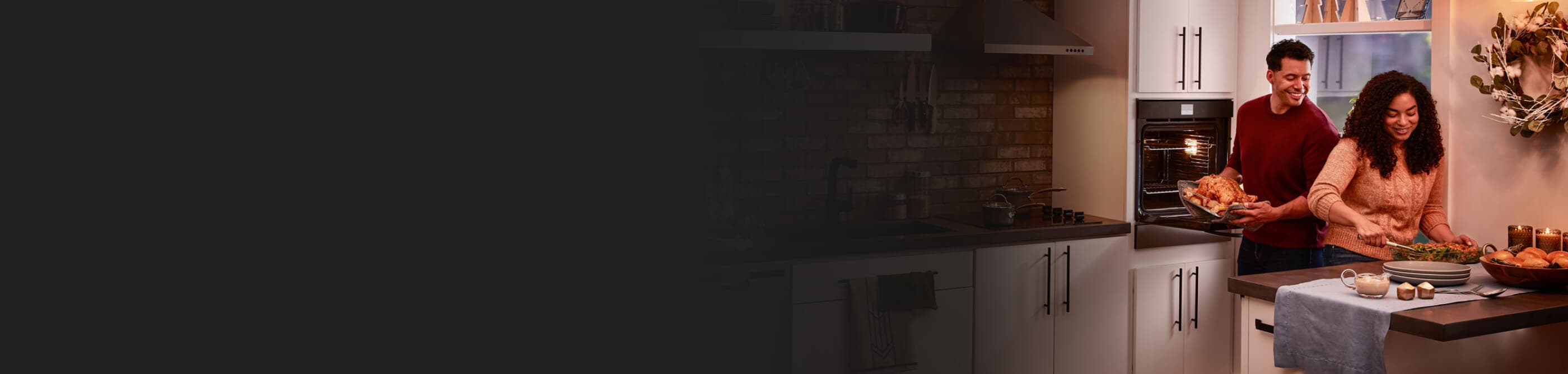People preparing dinner fixings in a single wall oven