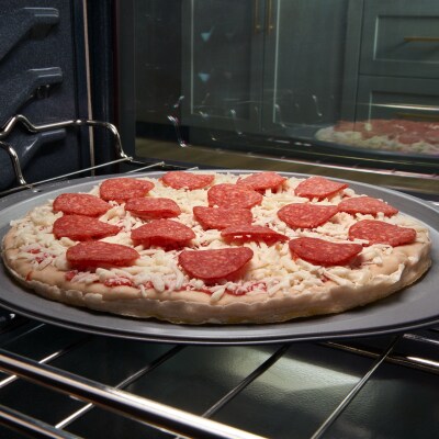 A frozen pizza in an oven