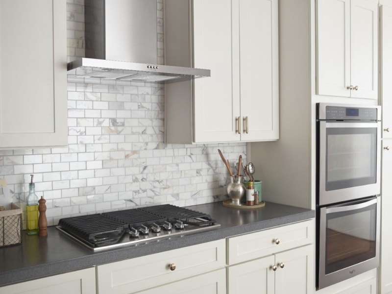 Stainless steel range hood over a cooktop