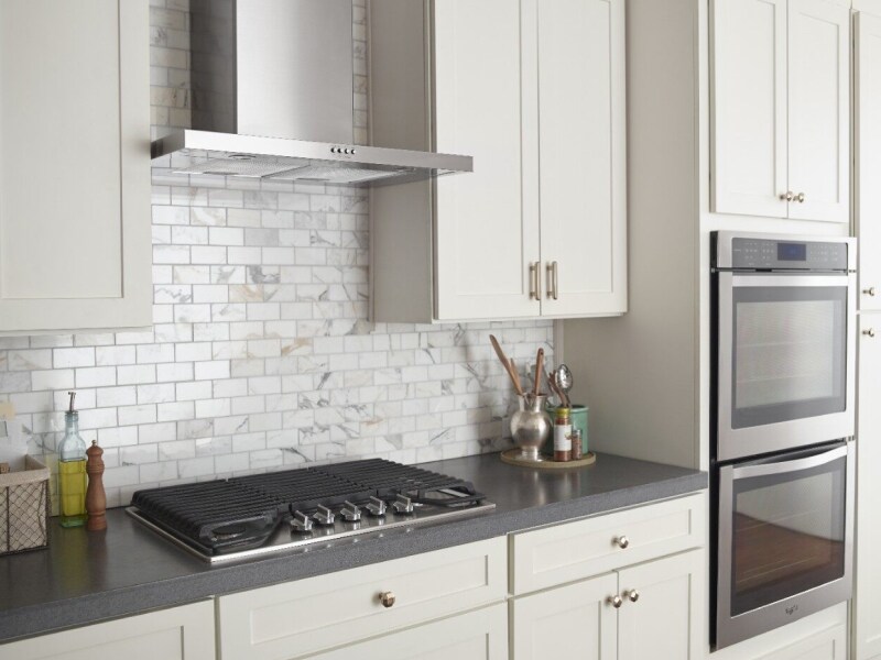 Stainless steel range hood over a cooktop