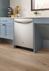 Top control dishwasher built into blue cabinets
