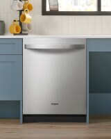 Top control dishwasher built into blue cabinets