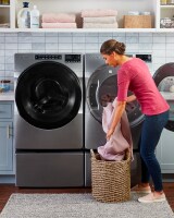 Person moving clothes to a dryer