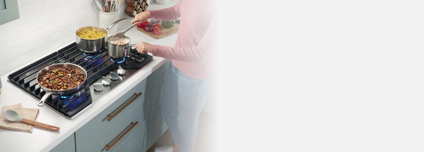 Person cooking on a gas cooktop