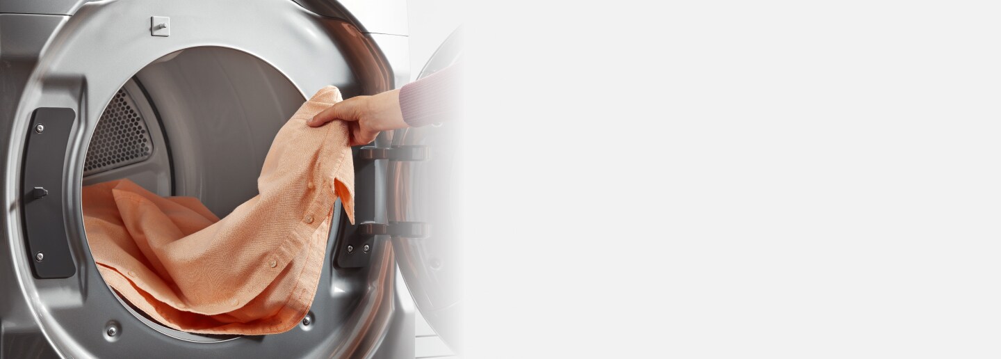 Person removing clothes from a Whirlpool® Dryer