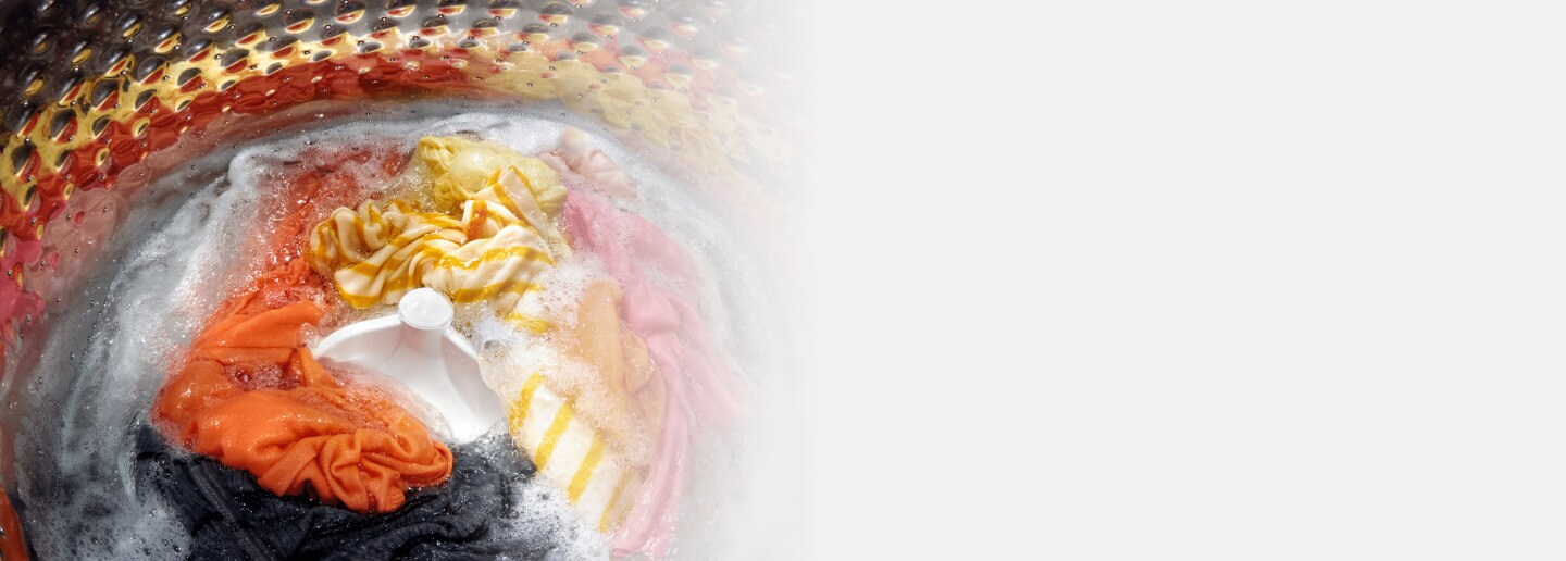 Laundry being washed in a top load washing machine with agitator