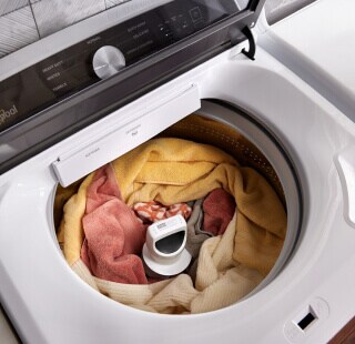 Orange and yellow clothes in a top load washer