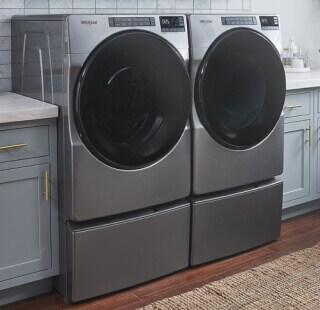 Front load washer and dryer set on laundry pedestals