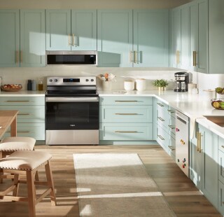 A stainless steel Whirlpool® Microwave and Whirlpool® Range in a kitchen