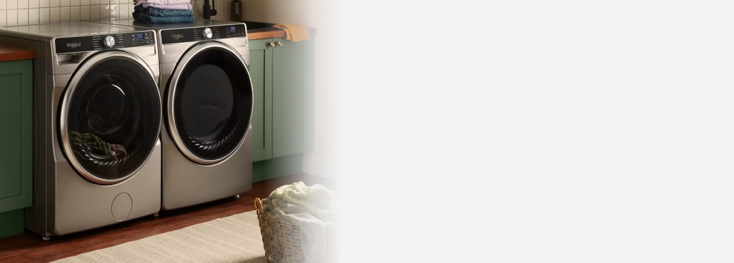 Front load washer and dryer set in a laundry room