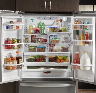 Side-by-side refrigerator doors open with a mix of colorful groceries inside