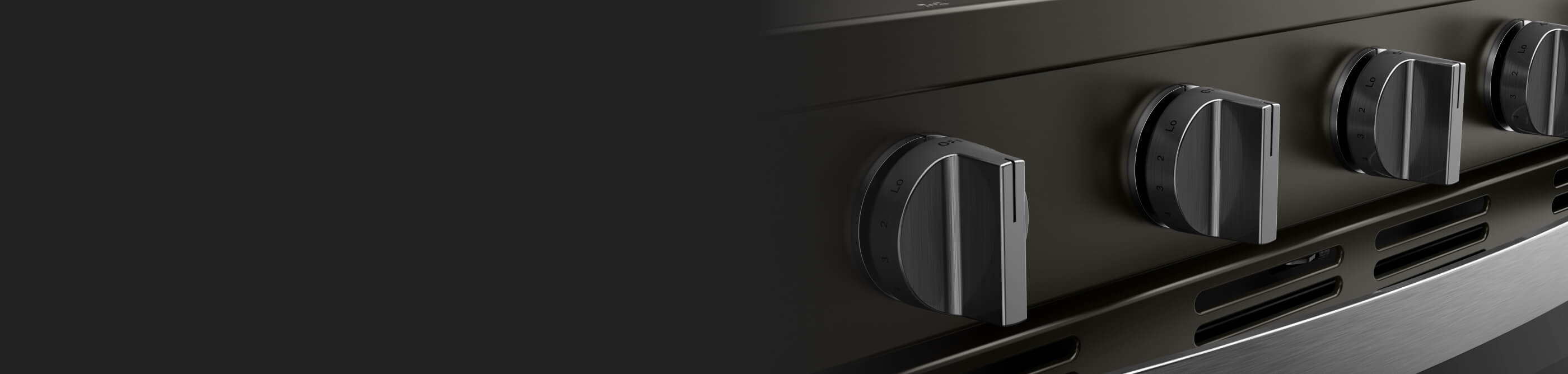 Closeup of the dials on the front of an oven