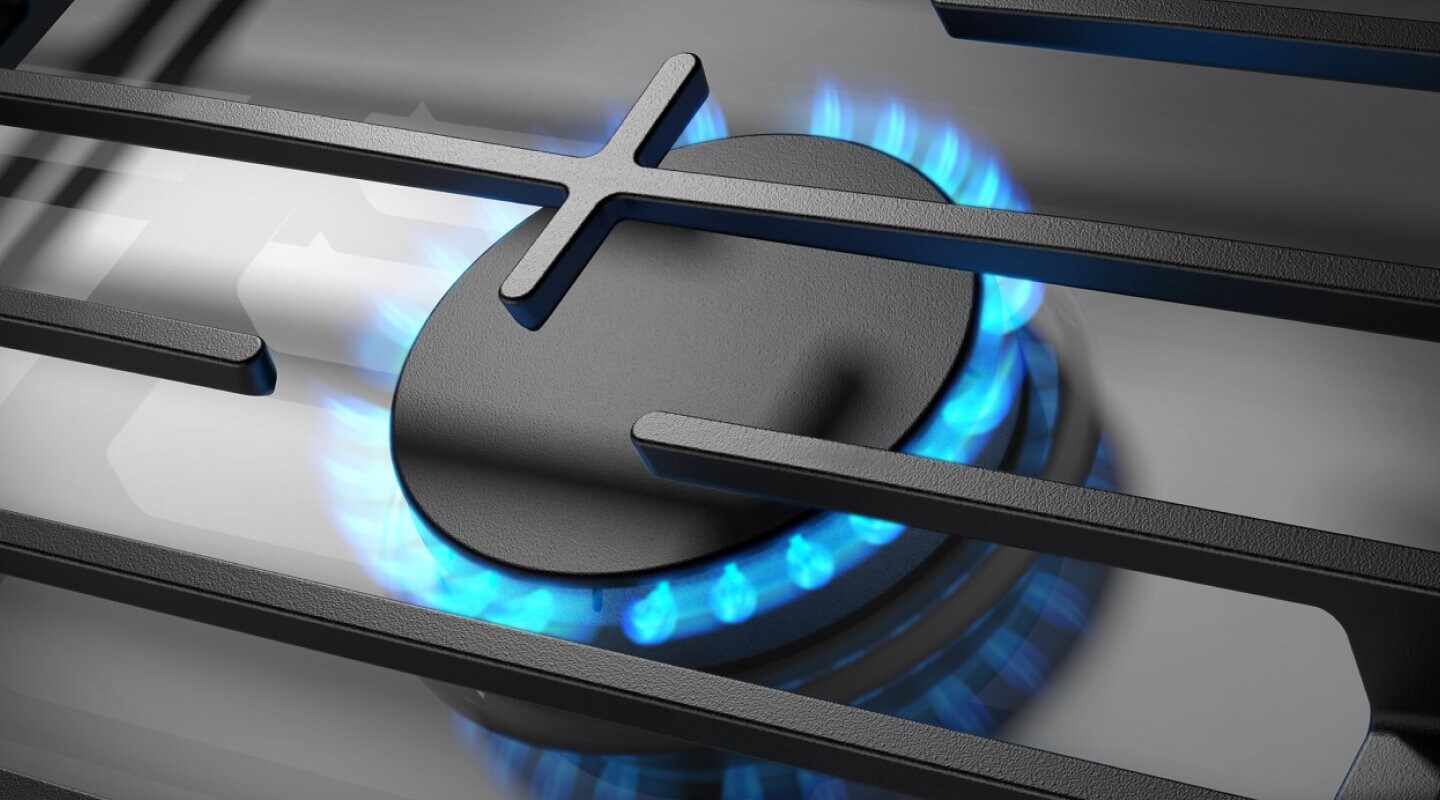 Close-up of blue flame on from a gas cooktop burner Close-up of blue flame on from a gas cooktop burner