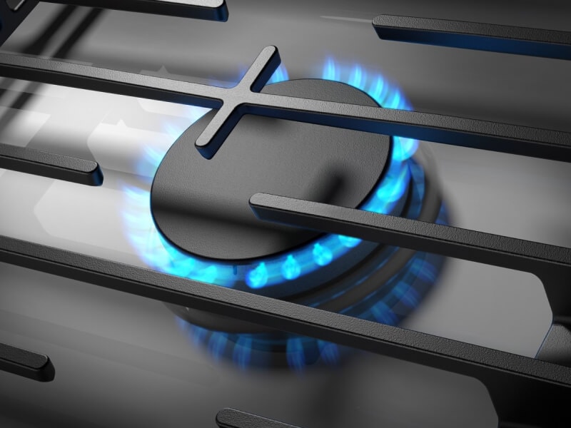 Close-up of blue flame on from a gas cooktop burner Close-up of blue flame on from a gas cooktop burner